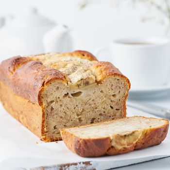 Banana bread, slice of cake with banana, side view, close up. The morning Breakfast on light grey background