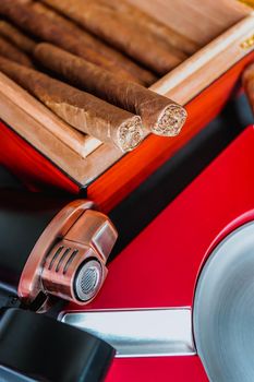 Open humidor with cigars, ashtray and cigar torch. Smoking set accessories. luxury lifestyle flat lay top view