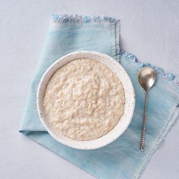 Oatmeal, healthy porridge in large bowl for breakfast. Top view, copy space