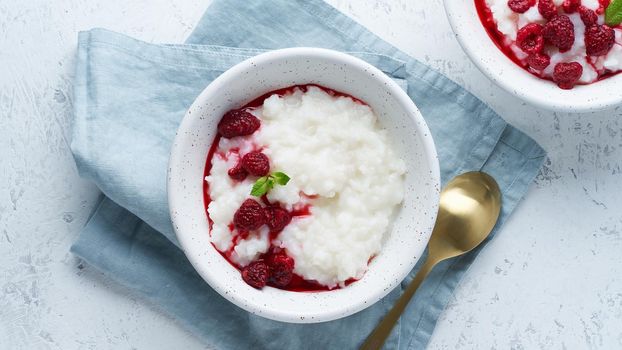 Rice Pudding. Long banner, Vegan Coconut diet breakfast with a coconut milk, raspberry, scandinavian minimalism, top view, copy space