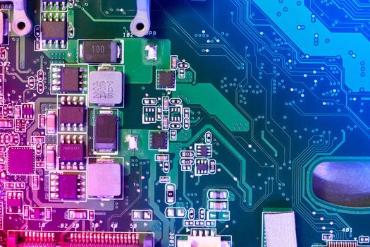 Computer motherboard background with blur neon multicolor glow