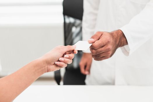 male hand giving white card