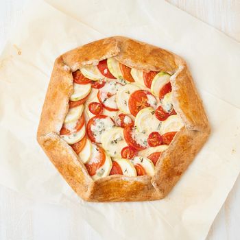 Step by step recipe. Homemade galette with vegetables, wholegrain pie. Top view, white wooden table