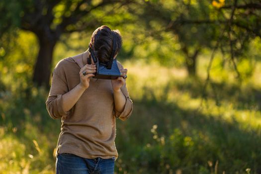 man wearing virtual reality glasses outdoors