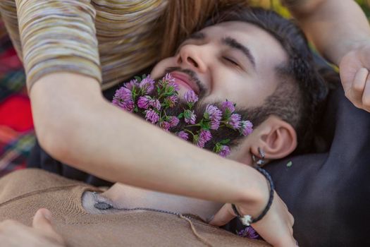 man with flowers in his beard