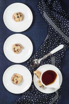 Porcelain dishes and cookies with cranberries. From series Playing with Color