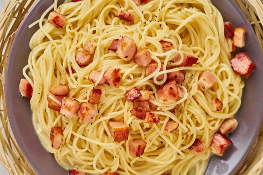 Close up carbonara pasta. Spaghetti with bacon, egg, parmesan cheese and cream sauce. Top view. Traditional italian cuisine.