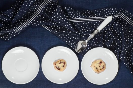 Porcelain dishes and cookies with cranberries. From series Playing with Color