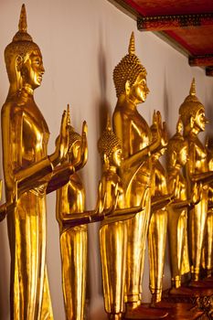 Standing golden Buddha statues close up. Wat Pho temple, Bangkok, Thailand