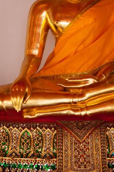 Sitting golden Buddha statue close up details. Wat Pho temple, Bangkok, Thailand