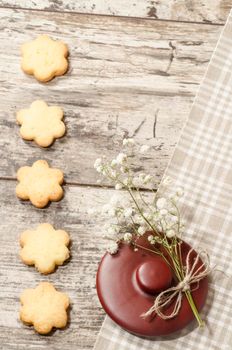 Homemade sugar cookies and flowers, background for greeting card. From the series Homemade Bakery