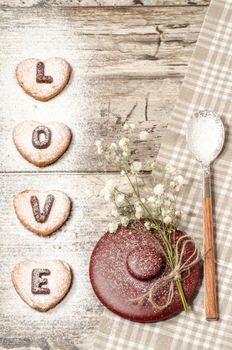 Homemade cookies Valentine's Day background for greeting card with beautiful flower and tableware. From series Winter pastry