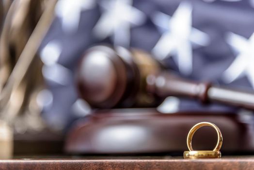 Golden wedding rings with judge gavel, closeup