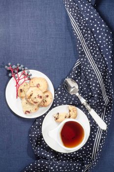 Porcelain dishes and cookies with cranberries. From series Playing with Color