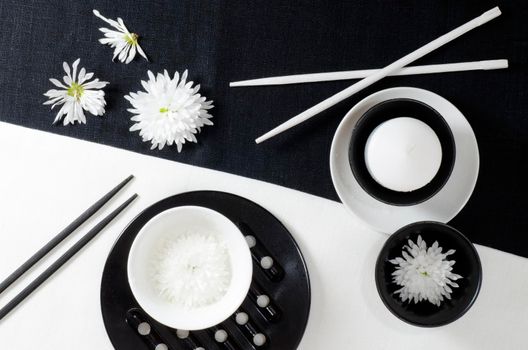 White porcelain on black and white linen tablecloths. White porcelain on black and white linen tablecloths. Abstract still life. From series "Playing with Color"