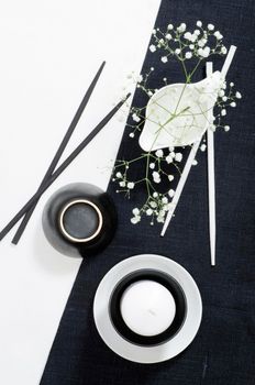 White porcelain on black and white linen tablecloths. White porcelain on black and white linen tablecloths. Abstract still life. From series "Playing with Color"