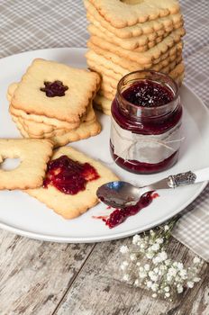 Homemade sugar cookies with jam decorated with flowers. From the series Homemade Bakery