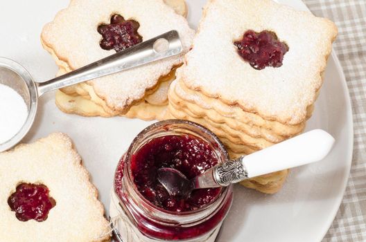 Homemade sugar cookies with jam decorated with flowers. From the series Homemade Bakery