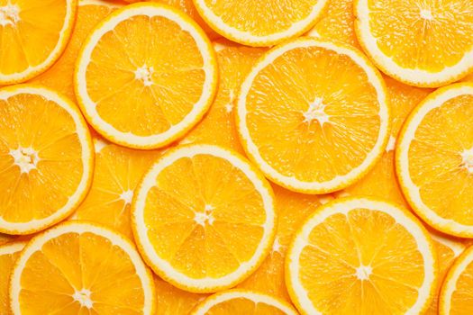 Colorful orange citrus fruit slices background top view