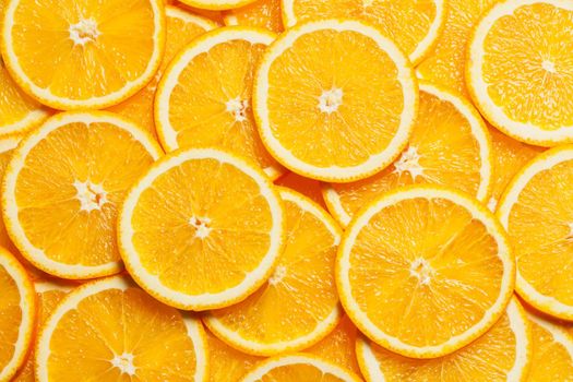 Colorful orange citrus fruit slices background top view