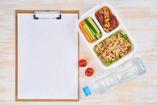 Clipboard, vegan lunch box, bottle. Healthy vegetarian menu, weight loss, healthy lifestyle