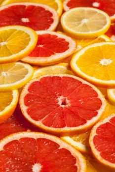 Colorful citrus fruit - lemon, orange, grapefruit - slices background