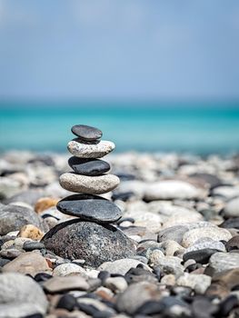 Zen meditation relaxation concept background - balanced stones stack close up on sea beach