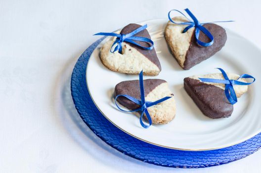 Cookies in shape of heart on plate. blurred background. From series "Valentine's Day"