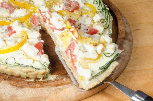 Ready vegetable pie on wooden cutting board. From series "Cooking vegetable pie"