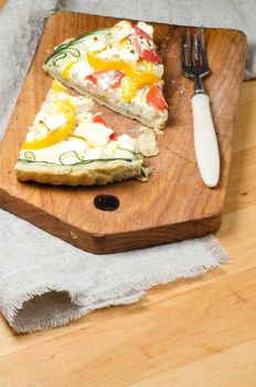 Two slices of vegetable pie on wooden cutting board. From series "Cooking vegetable pie"