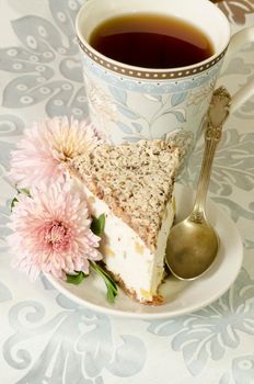 Ricotta and Pear Cake with cup of tea and bouquet of chrysanthemums. From the series "Italian desserts"