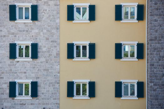 Windows with shutters on an apartment building.