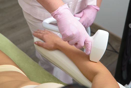 Laser hair removal procedure on ladies hand