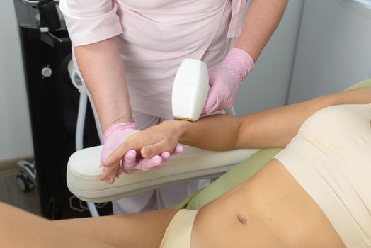 Laser hair removal procedure on ladies hand