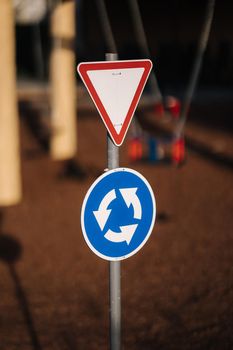 Traffic signs on the playground in the mini city for children. Toy city.