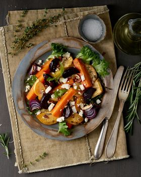 Vegetarian salad sheep cheese, baked roasted vegetables, keto ketogenic dash diet. Mix of carrots, beets, turnips, rutabaga, onions and a nuts. Clean eating. Top view, vertical