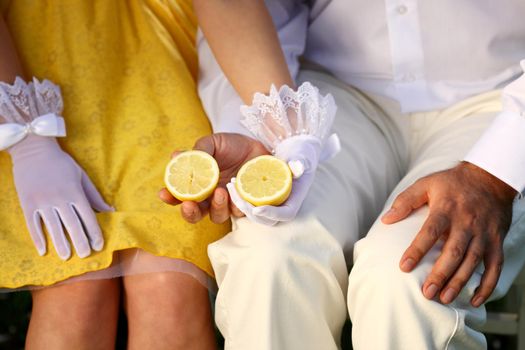 couple in love holding a cut lemon