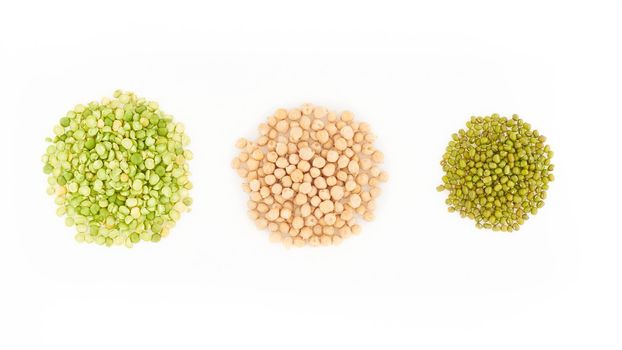 three kinds of raw dried legumes - chickpeas, mung bean, green peas, isolated on a white background