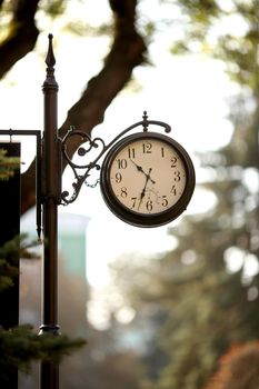 Classic vintage clock, railway station in summer time