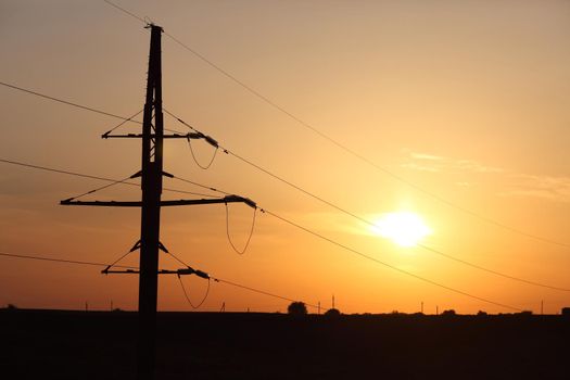 Electricity Pillars against a colorful yellow sunset