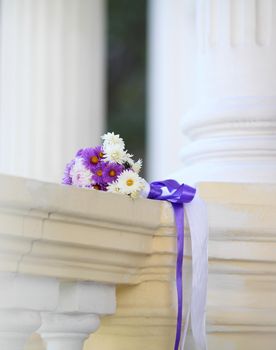 beautiful bridal bouquet on antique railing on the background of columns