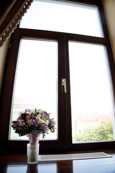 Elegant bridal bouquet near window.