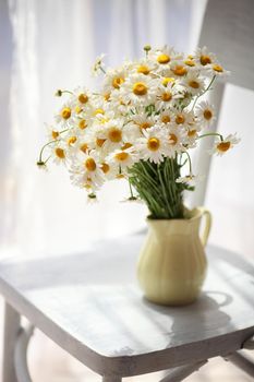 Bouquet of wildflowers on a rustic table at country cottage