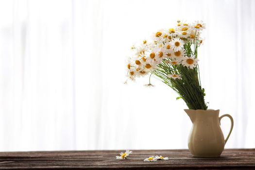 Bouquet of wildflowers on a rustic table at country cottage