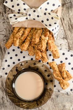 Garlic cheese bread sticks and cup of black tea with milk From series Homemade bread