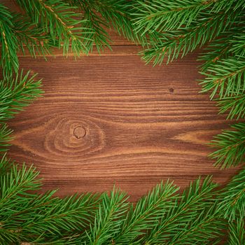 Christmas and Happy New Year dark brown background. Top view, copy space, wooden rustic table, fir branches, close up
