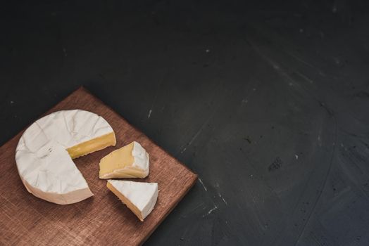 cheese camembert with mold on the wooden cutting board