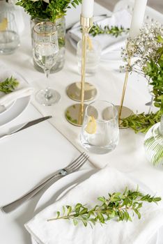Wedding table set up in taditional style with roses grass and greenery. Wedding table scapes