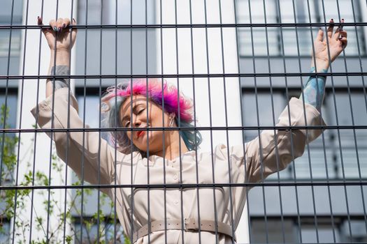 Portrait of a middle-aged woman with multi-colored hair walks on the streets of the city