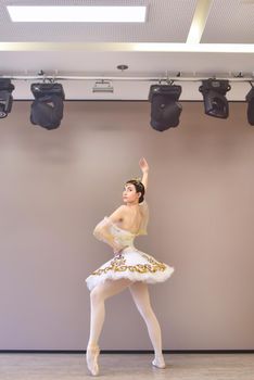 Young beautiful ballet dancer practice to make pirouette in the dance studio